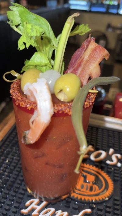 Bloody Mary garnished with shrimp, bacon, olives and celery